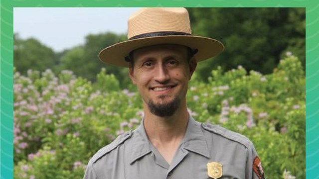 A ranger standing in front of a field.