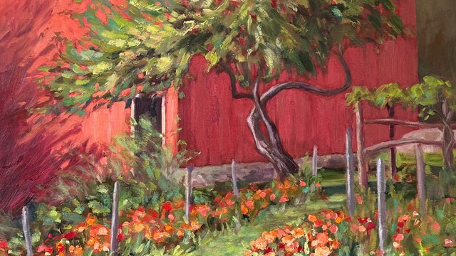 A painting of orange and red flowers growing in a garden. There is a red building with an open door.