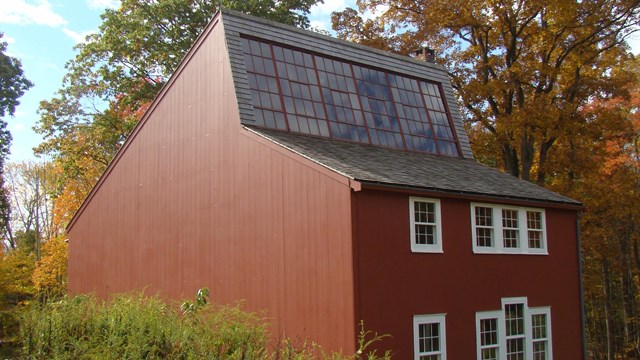 A red building with white trim and several windows.
