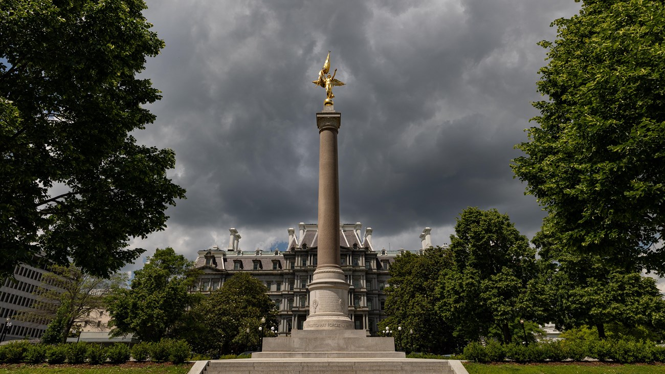 Square fountain with rounded basin displayed against a blue sky