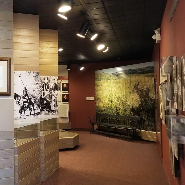 a hallway with a welcome sign leading into a museum