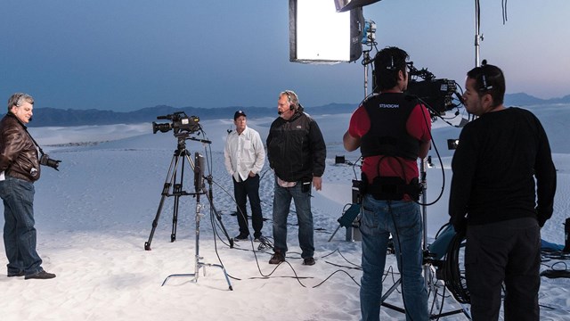 Cameras and lighting equipment on dunes. 