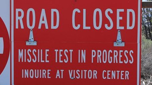 Monument closure sign on gate.