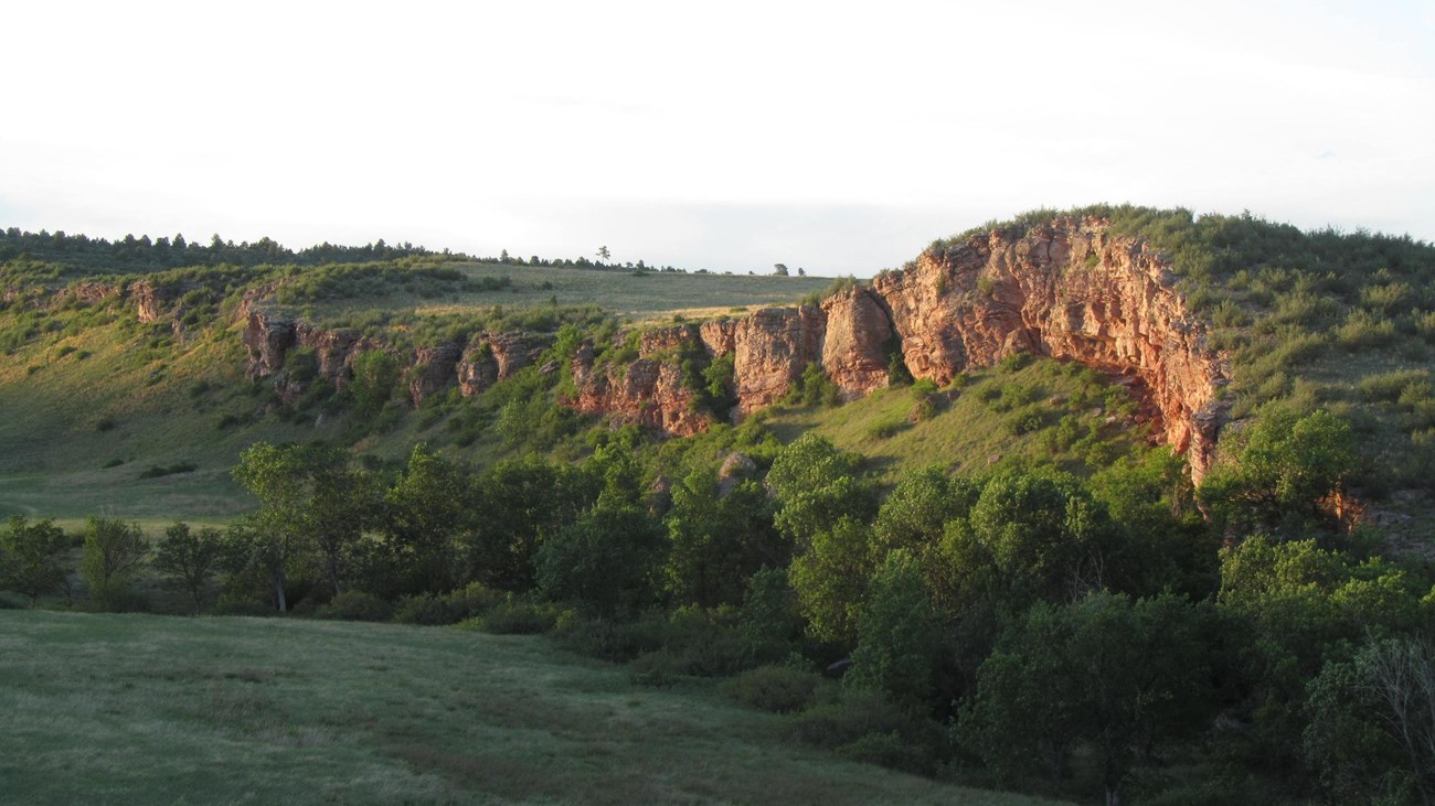 A ridge and cliff jutting out from the prairie.