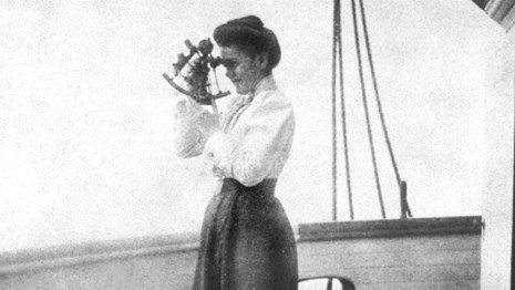 Black and white photo of a woman holding a sexton. Courtesy of NPS. 