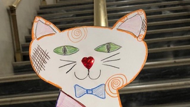 Image of a paper cat hand-colored. NPS photo.