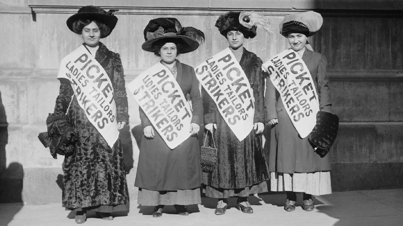 Women picketers on a city street.