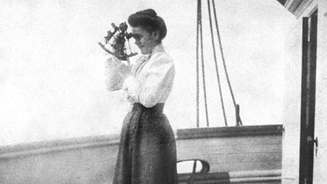 Woman doctor taking patient's pulse. Courtesy of the Library of Congress.