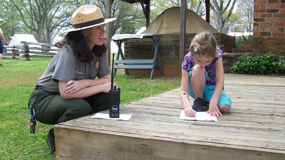 Ranger talking to a child. Courtesy NPS