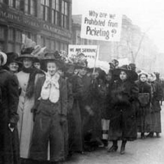 Women picketers on a city street.