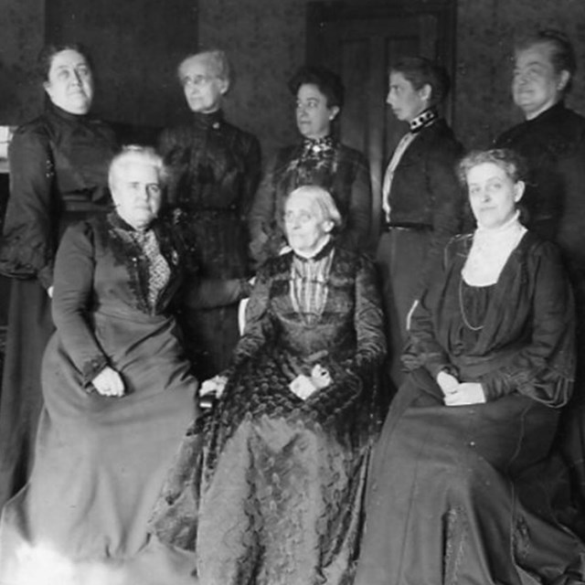 Black and white photo of a group of women including Catt, Anthony, and Shaw