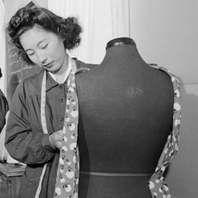 Woman sewing clothing on a mannequin. NPS photo. 