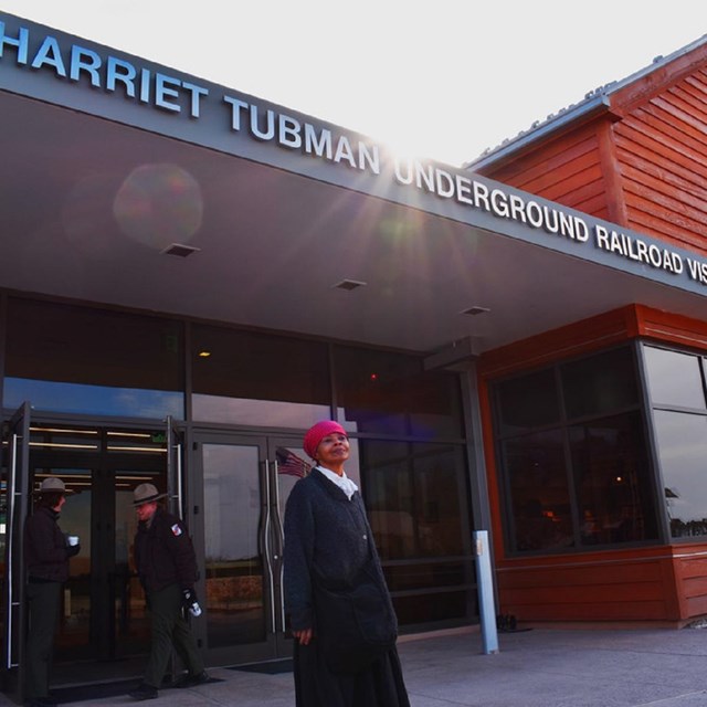 Visitor center with interpreter dressed as Tubman out front. Courtesy NPS. 