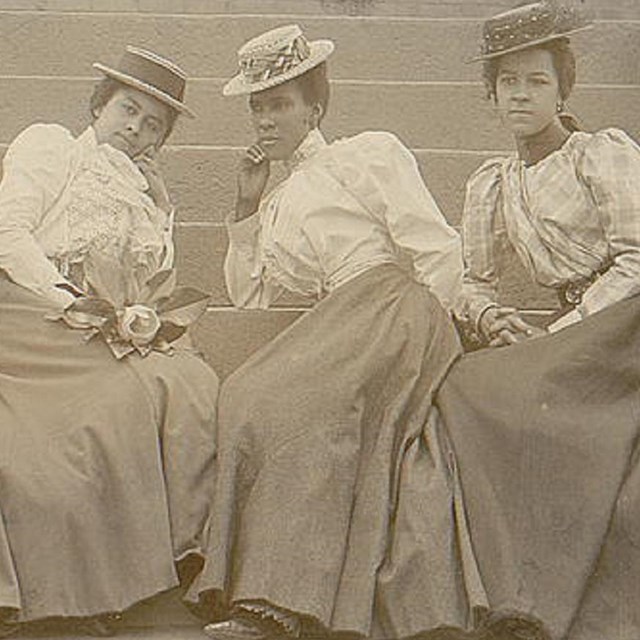 Four black women sitting together. Library of Congress photo. 
