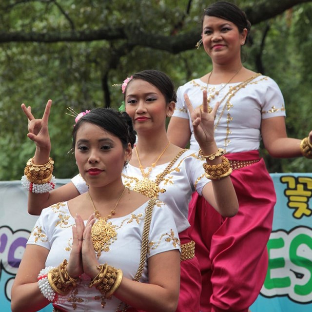 Three women in traditional clothes perform a dance. Photo courtesy NPS.