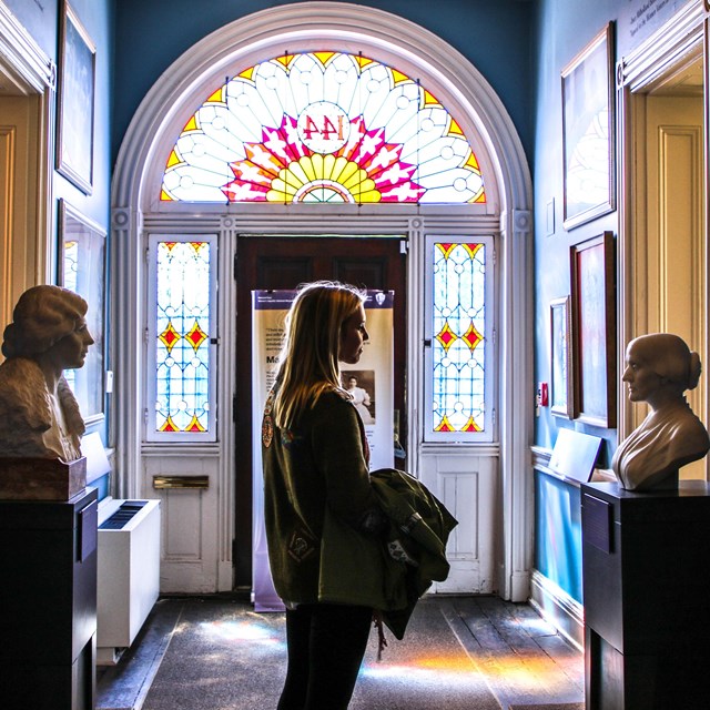 Interior of the entryway to the house with large mirror and busts. Courtesy National Woman's Party.