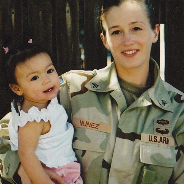 A woman in uniform holding a child