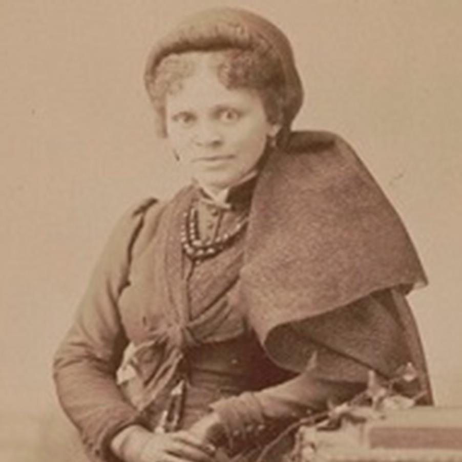 Black and white portrait of Hallie Brown in a large coat