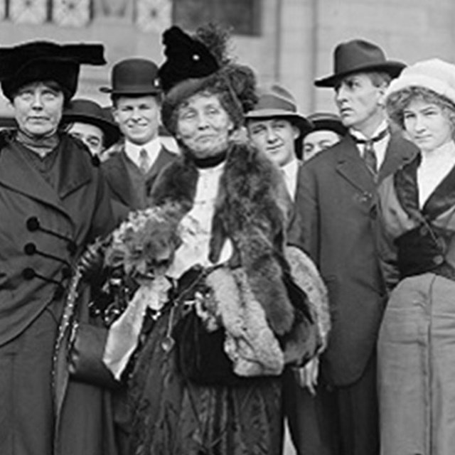 Photo of Emmiline Pankhurst surrounded by other people. LOC