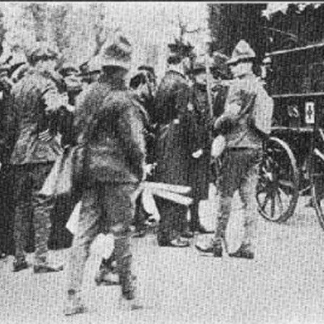 Detail of Boy Scouts helping near an ambulance at the suffrage parade. From Boys' Life, April 1913