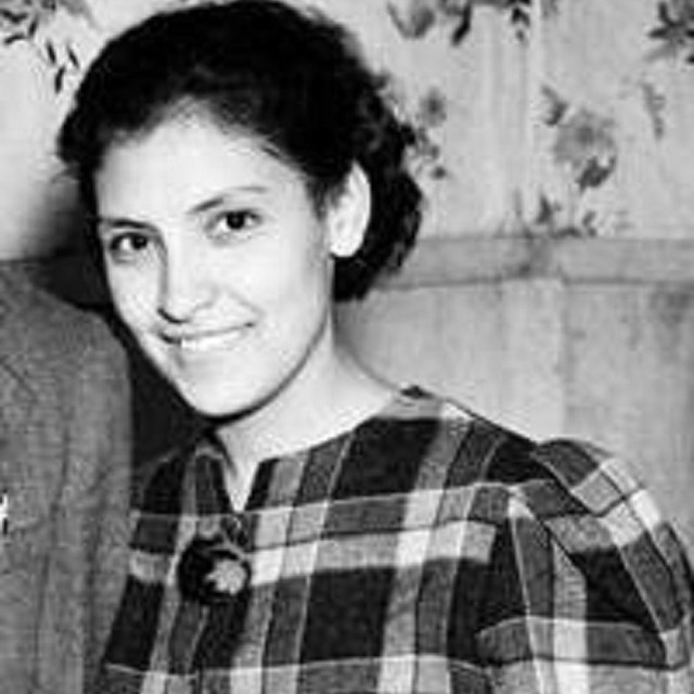 Young woman wearing a plaid dress.