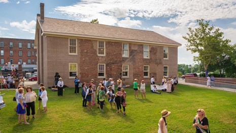 A view of the Wesleyan Chapel with a crowd outside.