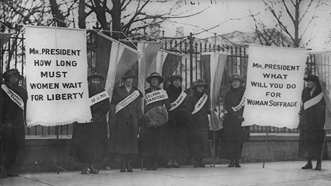 A historical photograph of women picketing the White House.