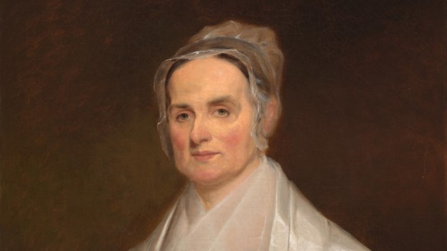 A painting of Lucretia Mott, wearing a sheer white bonnet and a silk shawl. NPG.