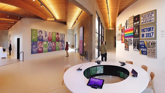 A large exhibit room with a circular table in the center