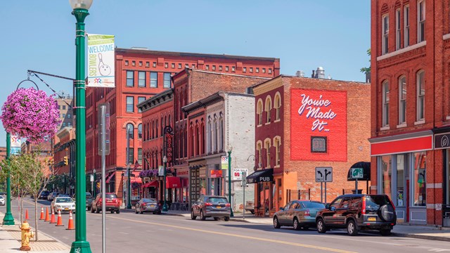 A city street with red brick buildings.