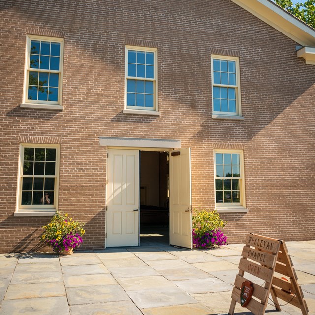 The front of the Wesleyan Chapel with the front door open.