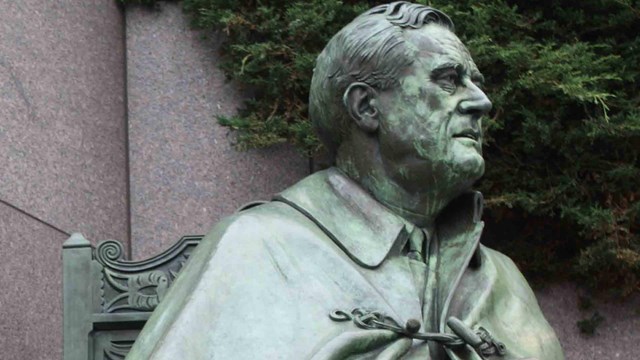 Bronze statue, greened, of Franklin D Roosevelt in cape