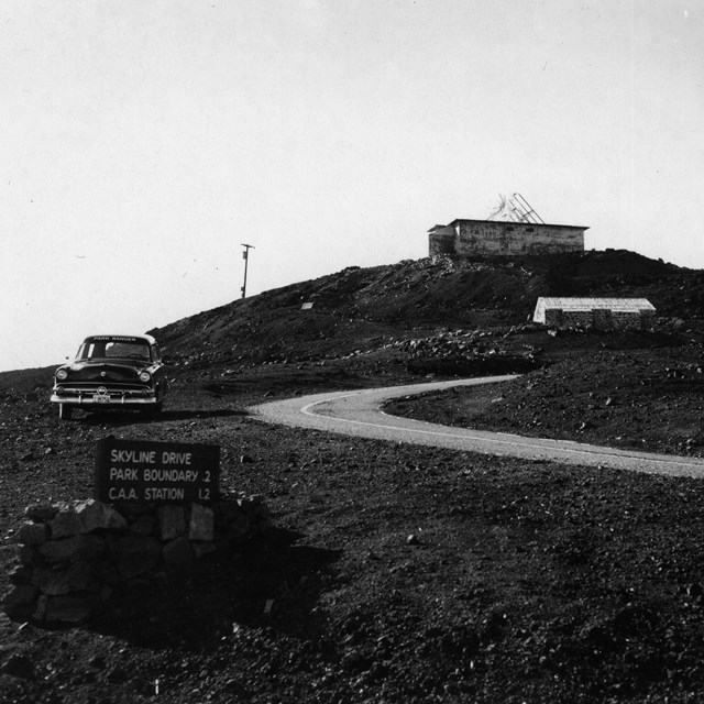B&W photo of building on lava hill