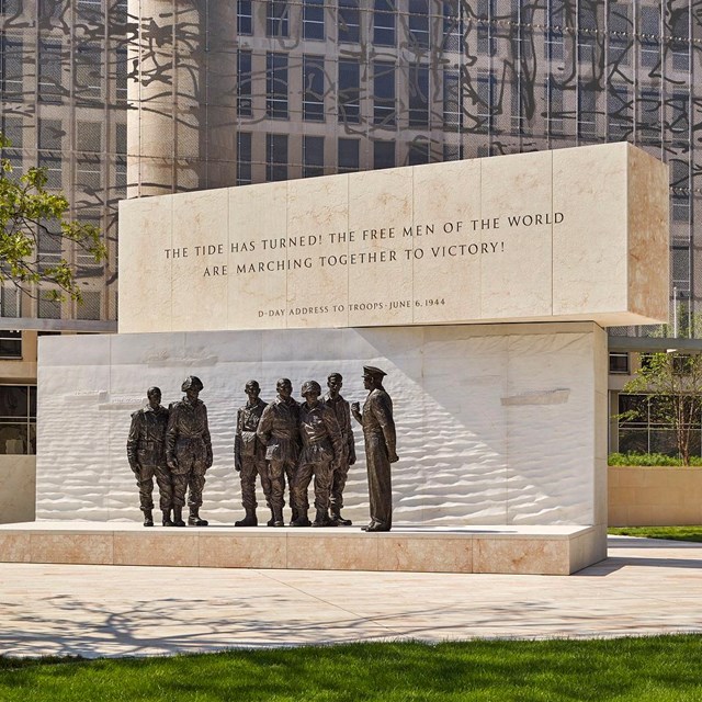 statue of eisenhower addressing multiple soldiers in uniform