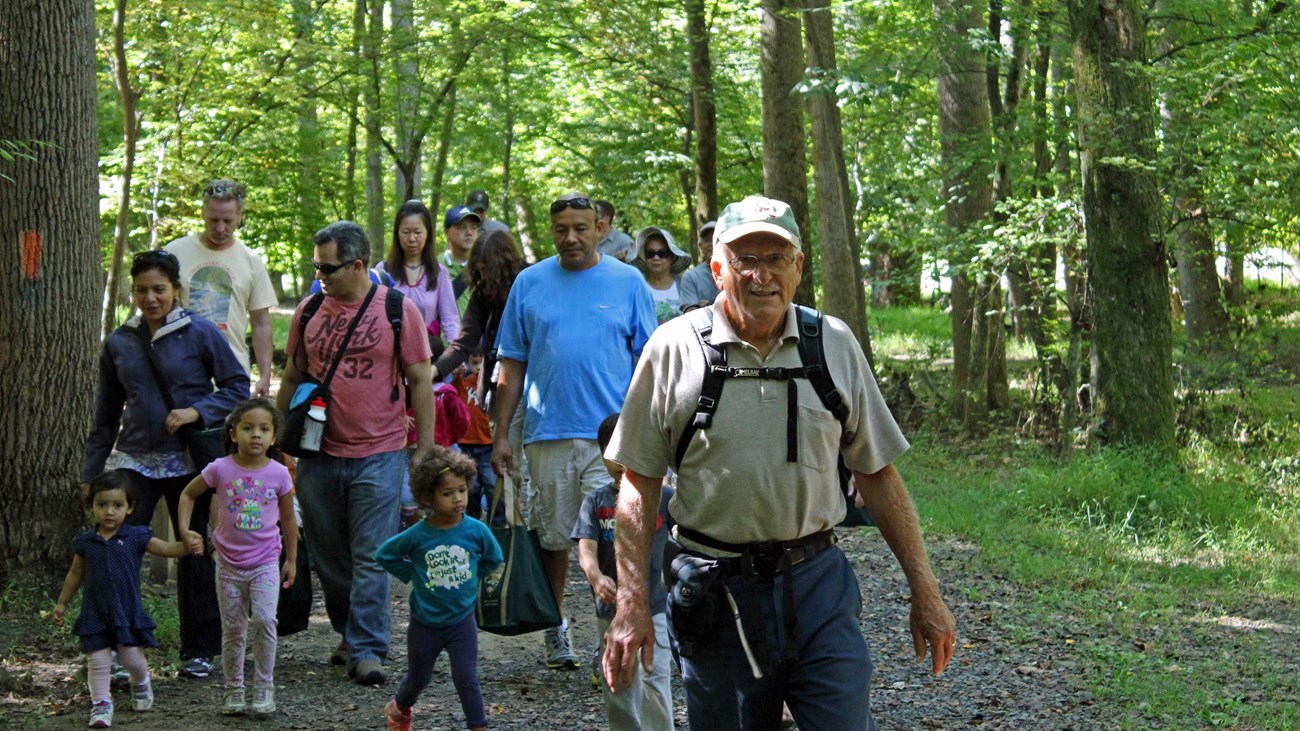 A group of visitors hike on the Wolf Trap Trail. 