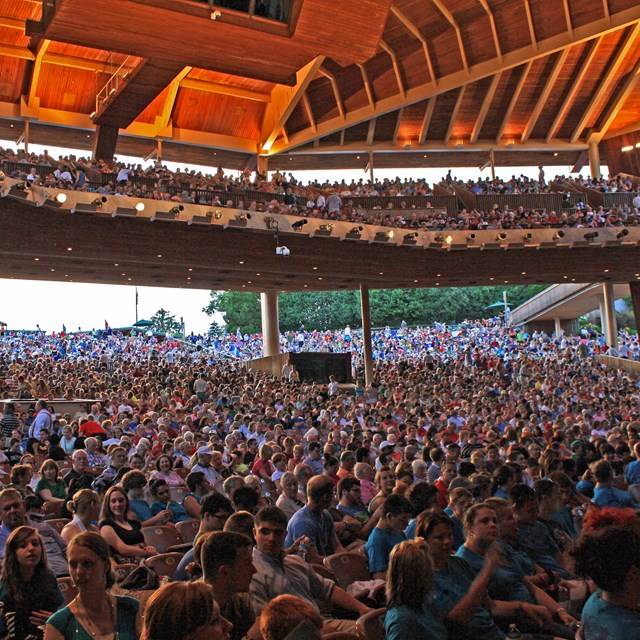 The seating area of the Filene Center with seated patrons