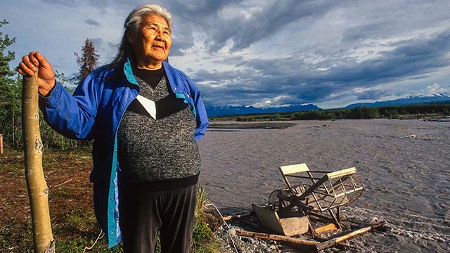 An image of Katie John standing near a fishwheel. 