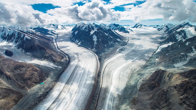 two glaciers joining between mountain ridges