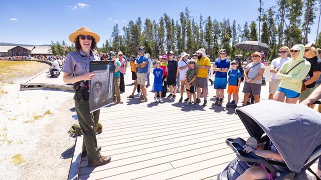 several visitors listening to a park ranger give a program