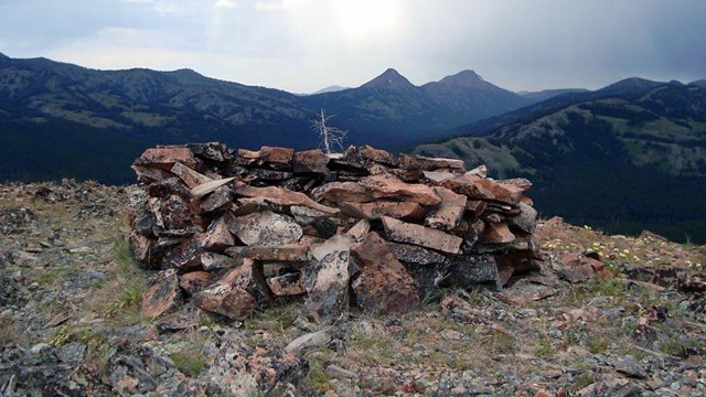 Rocks covered in lichen arranged in the shape of a tall fire ring on a mountain top