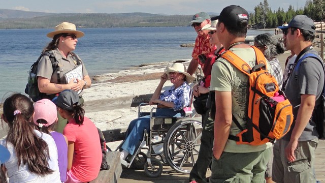 Park ranger discussing park resources with visitors at West Thumb Geyser Basin