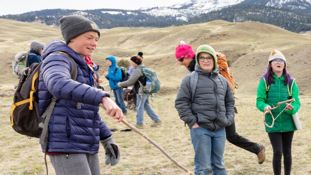 Students play a traditional Native American game outside.