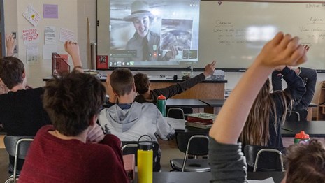 A ranger displayed on a screen in a classroom.