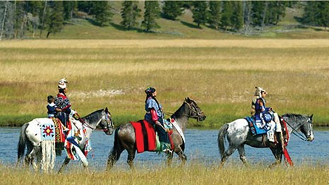 Three Nez Perce on horseback.