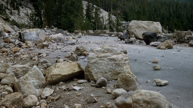 Rocks cover the Grand Loop Road near Gibbon Falls after an earthquake.