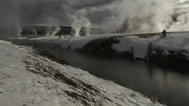 Steam plumes from hydrothermal features near Firehole River.
