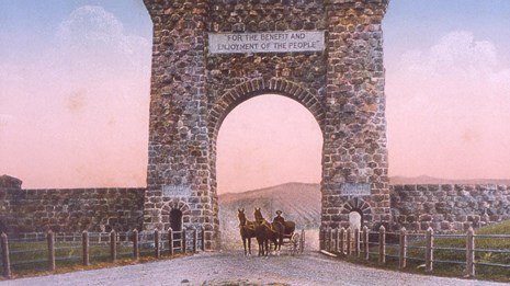 Historic colorized photograph of horses going under a large stone arch.