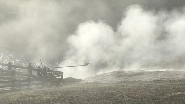 Two filmmakers capture footage of an outwash channel during a misty, steamy morning.