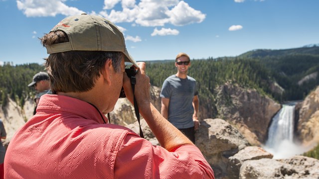 A photographer taking a portrait of a man.