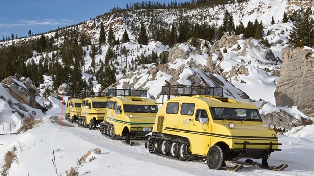 Bombardiers make their way through the rocky formation called the Hoodoos on the way to Mammoth.